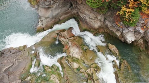 Closeup View of Astonishing Waterfall Towering Above Rocky Cliff