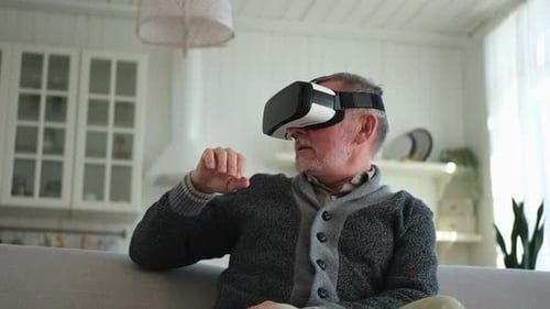 Senior Man Experiencing Virtual Reality Headset at Home