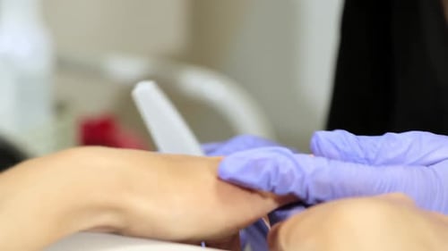 Professional Master in Gloves Makes Manicure for Customer