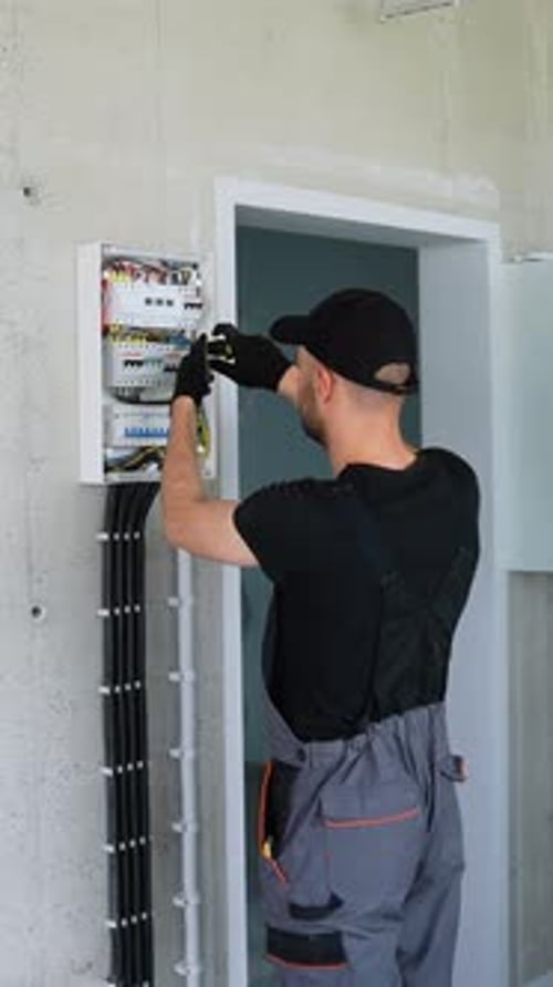 Electrician Installing Electrical Panel in Office or House Vertical Video