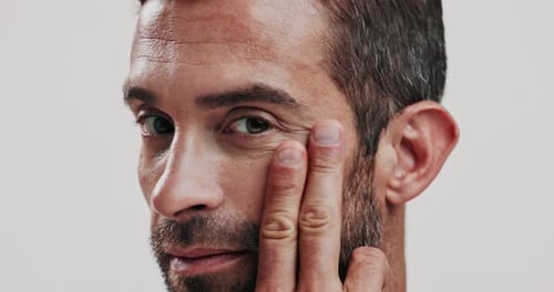 Skincare, natural and face of man with serum in studio for cosmetic, health