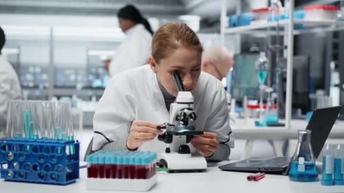 Scientist works with microscope in modern lab
