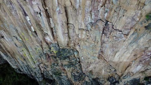 Rock Climber Ascends Sheer Cliff Face