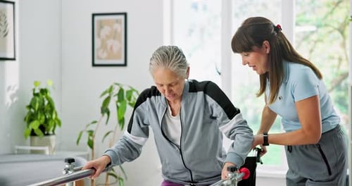 Elderly woman, wheelchair or walking with physiotherapist on rail for balance or mobility in clinic