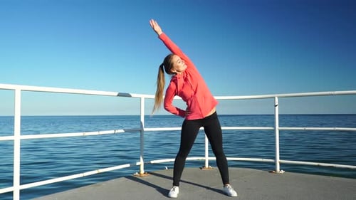 Woman Jogger Stretches on Sea