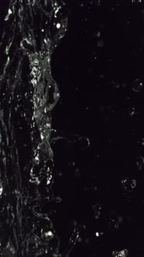Abstract Water Stream Flowing Against Black Background