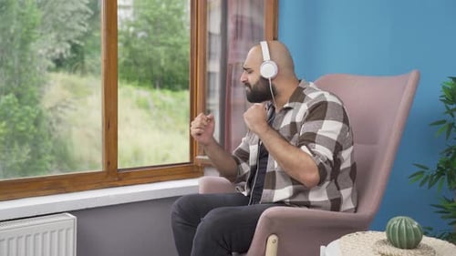 Man Enjoying Music, Relaxing in Chair with Headphones