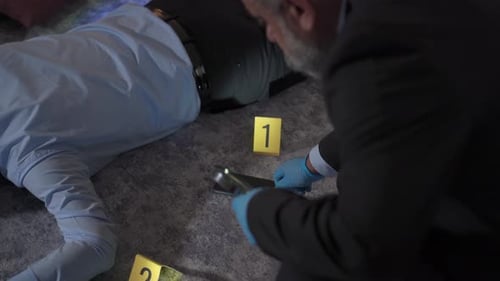 Investigator Examines Crime Scene with Evidence Markers