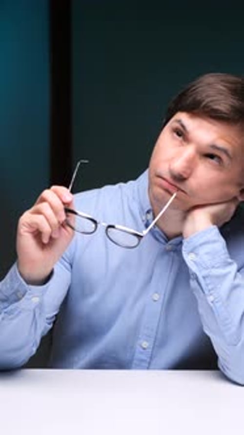 Vertical Video Portrait Thoughtful Man Contemplating Ideas at Desk in Office