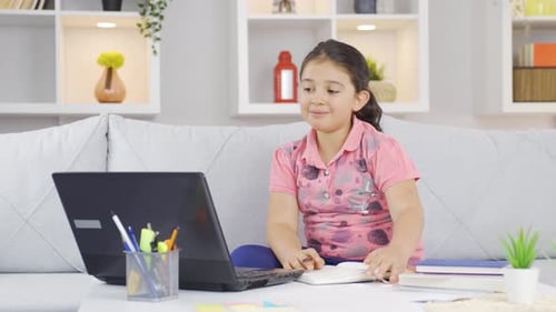 Child Using Laptop for Online School at Home