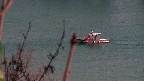 Small fishing boat slowly moving through the sea