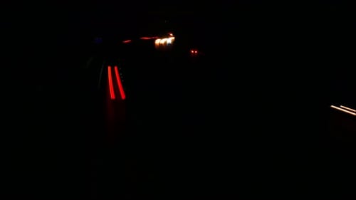 Dynamic, long exposure motorway hyper lapse, busy road, freeway. Light rails show a congested Britis