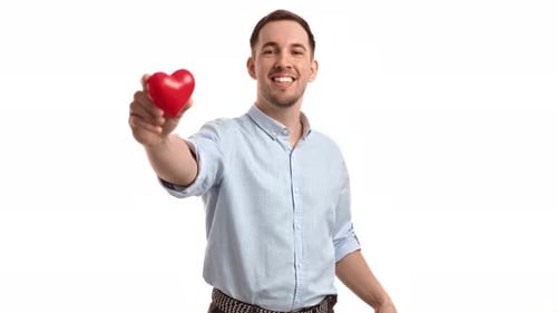 Man Holds Out Red Heart Offering Love