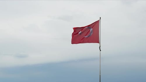 Turkish Flag Waving Against Overcast Sky