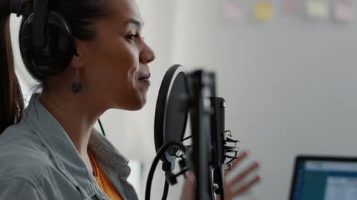 Woman Recording Audio in Professional Studio Setting