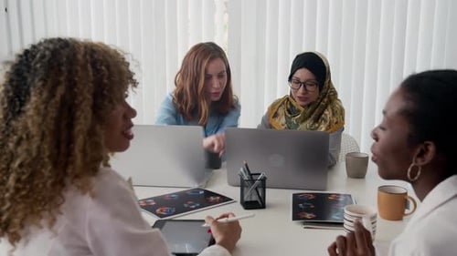 Diverse Women Collaborating at a Business Table Meeting