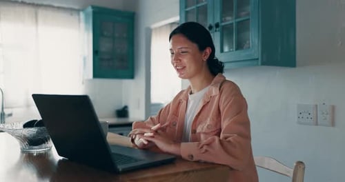 Woman Video Chatting on Laptop in Kitchen