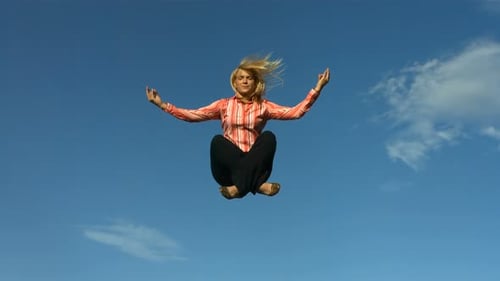 Woman Meditating in the Air Against Blue Sky