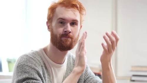 Bearded Man Smiling and Clapping in Home Setting