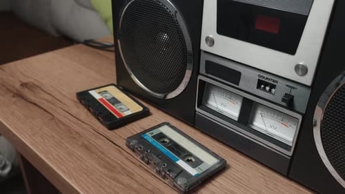Vintage Boombox with Audio Cassettes on Table