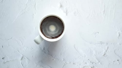 Top View of Stirring Coffee with Spoon Slow Motion