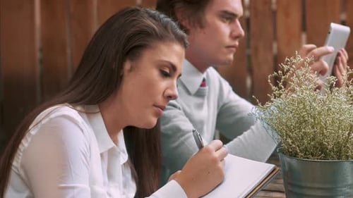 University students study together on campus with laptops tablets and textbooks