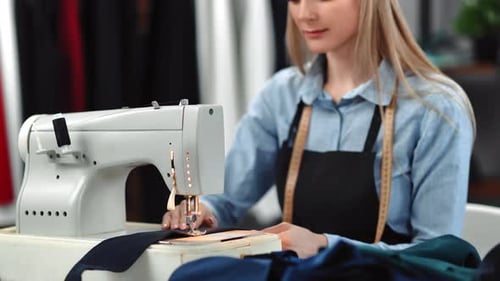 Woman Sewing Fabric at a Sewing Machine