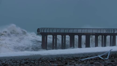 stormy sea waves with bridge in foreground
