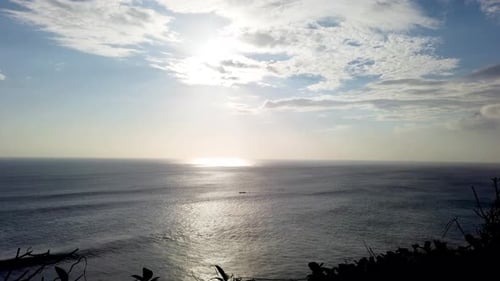 Beautifull small fisherman boat crossing the sea with clear blue sky and calm waves during sunset ti