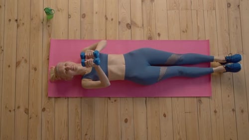 Top View of Sporty Fit Senior Woman Working Out Dumbbell Inner Chest Press