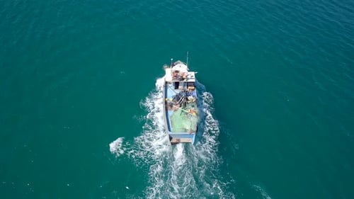 Small fishing boat at sea - Aerial footage.