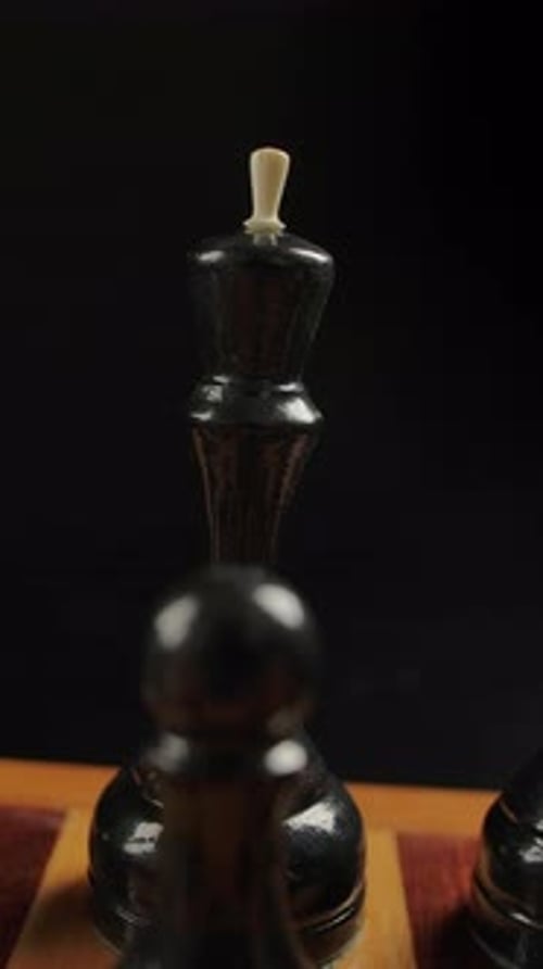 Chess Pieces on Board with a Dark Background