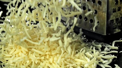 The Grated Cheese Falls on the Table Filmed on a Highspeed Camera at 1000 Fps
