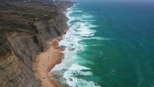 Explore the Stunning Coastline With Waves Crashing Against Cliffs at Sunset