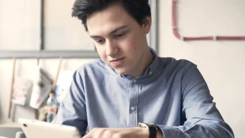 Young Happy Teenager with Tablet Computer During Lunch in Cafe Adolescent