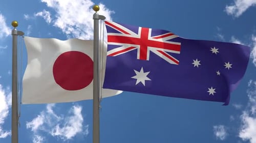 Flags of Japan and Australia Waving in Blue Sky
