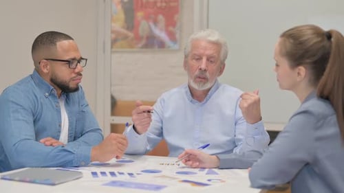 Business Meeting with Charts and Graphs