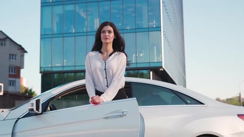 Elegant Woman Exiting Car in Urban Setting