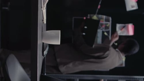 Man Works at Desk with Laptop in Office