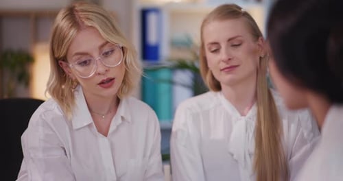 Three Colleagues Collaborating in Office Meeting
