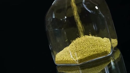 Hourglass with Flowing Gold Sands in Slow Motion