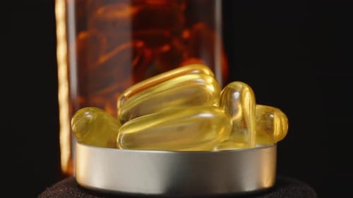 Yellow Gel Capsules Rotating in Macro Shot