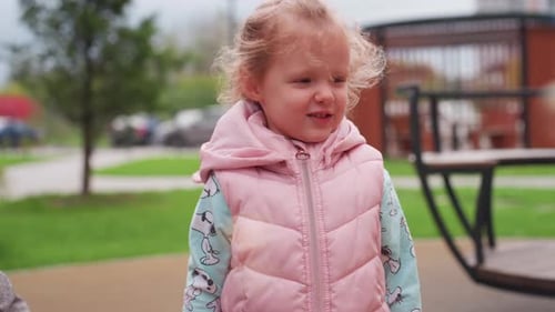 Girl Blowing Bubbles in a Park on a Cloudy Day