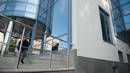 Young man running and jumping above obstacle in the city at daytime