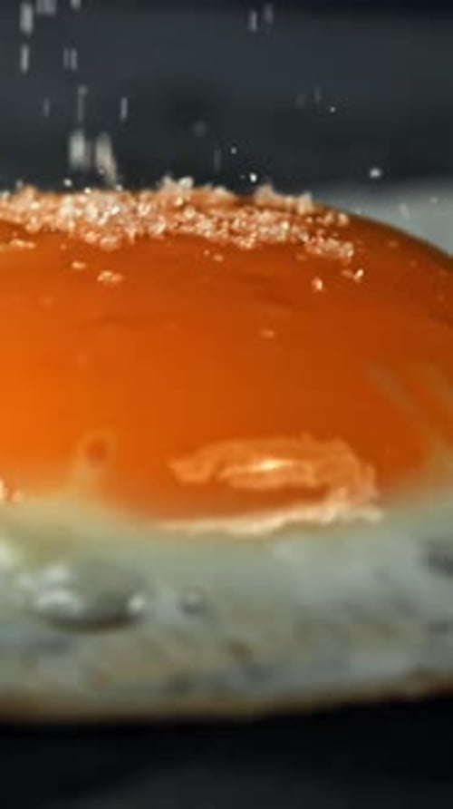 Salt Falls on the Fried Egg Filmed on a Highspeed Camera at 1000 Fps