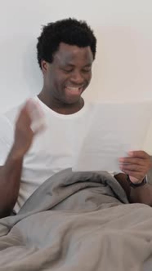 Man in Bed Receives Good News