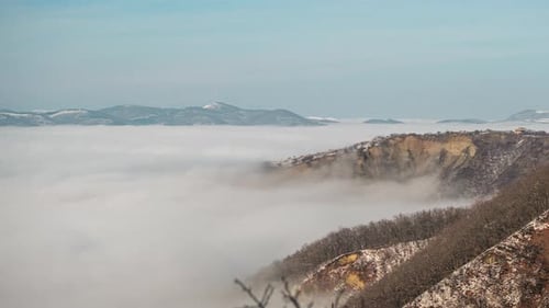 Timelapse shot over the clouds while sunrise sky. A sea of fog is formed from stratus. Foggy valley