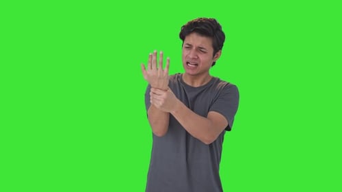 Indian man suffering from hand pain Green screen