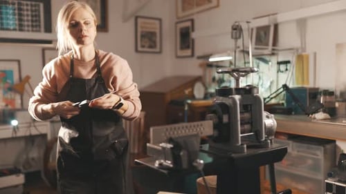 Woman Crafting Jewelry with Rolling Mill in Workshop