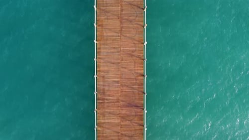 Wooden pier in the sea top view aerial 4K